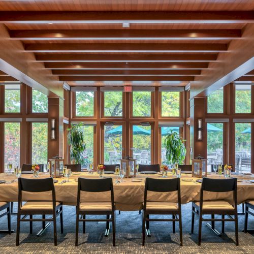 A traditional Japanese-style dining area with wooden beams, lanterns, and sliding shoji doors, low tables, and tatami seating.
